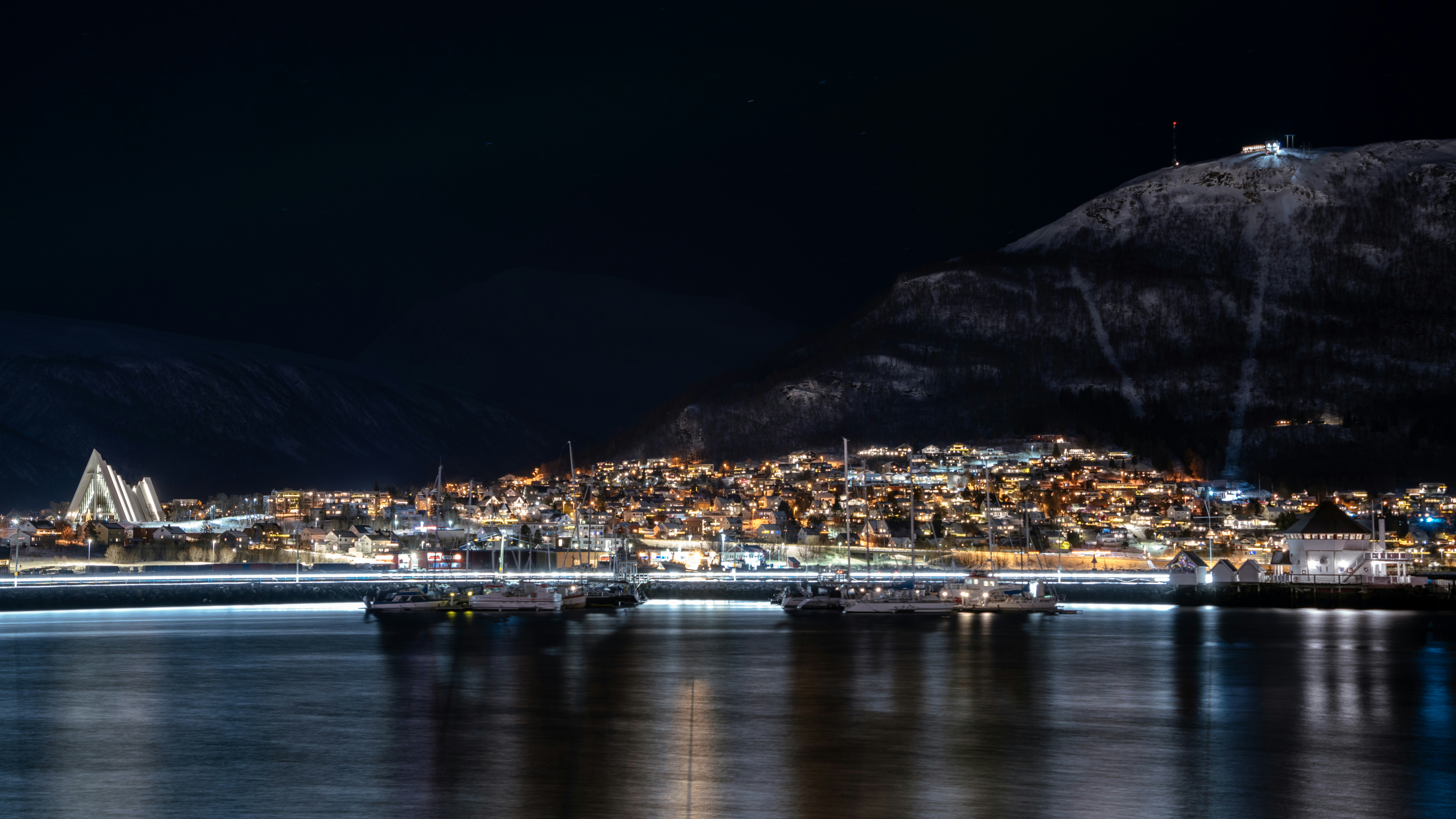 a large body of water with a city in the background