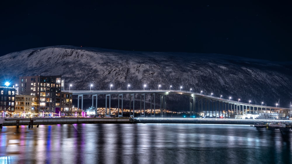 a night view of a bridge over a body of water