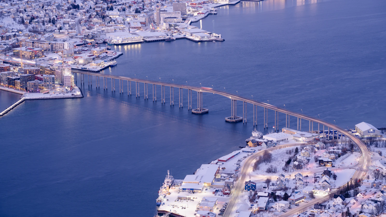 Tromsø city, bridge and surrounding fjords during blue-hour light