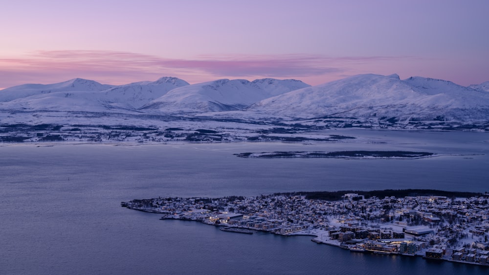 a view of a city and a body of water with mountains in the background