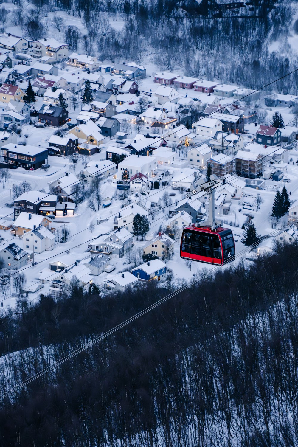 a red bus traveling down a snow covered road
