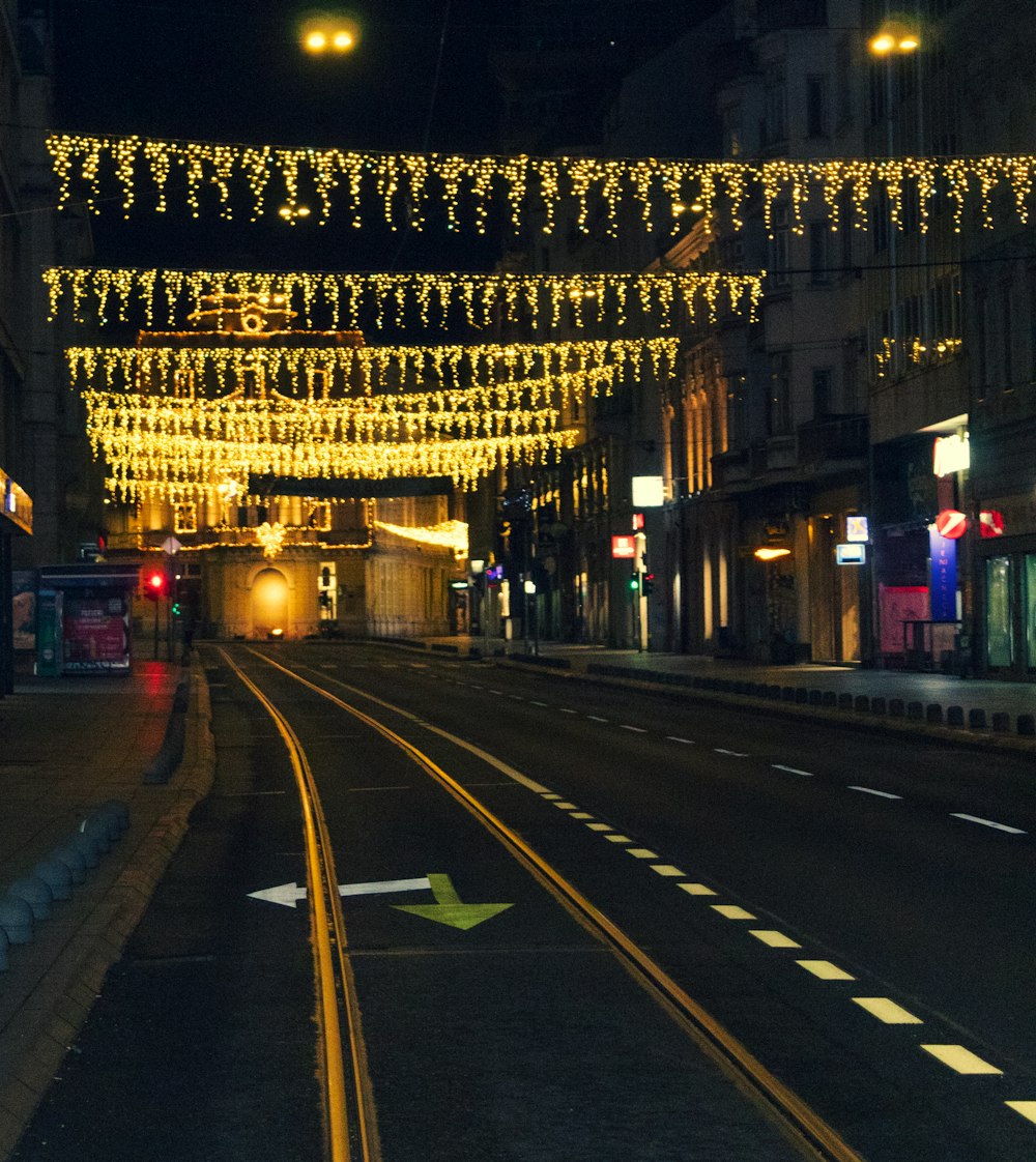 a city street with lights strung over it