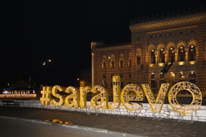 a large sign that says love is lit up in front of a building