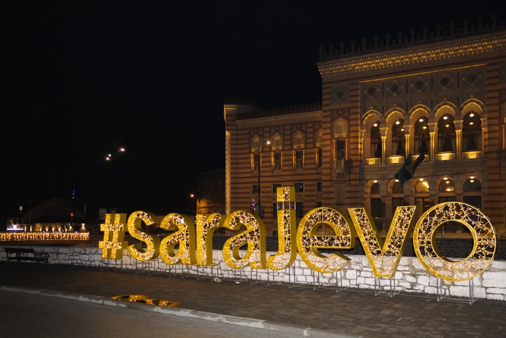 a large sign that says love is lit up in front of a building