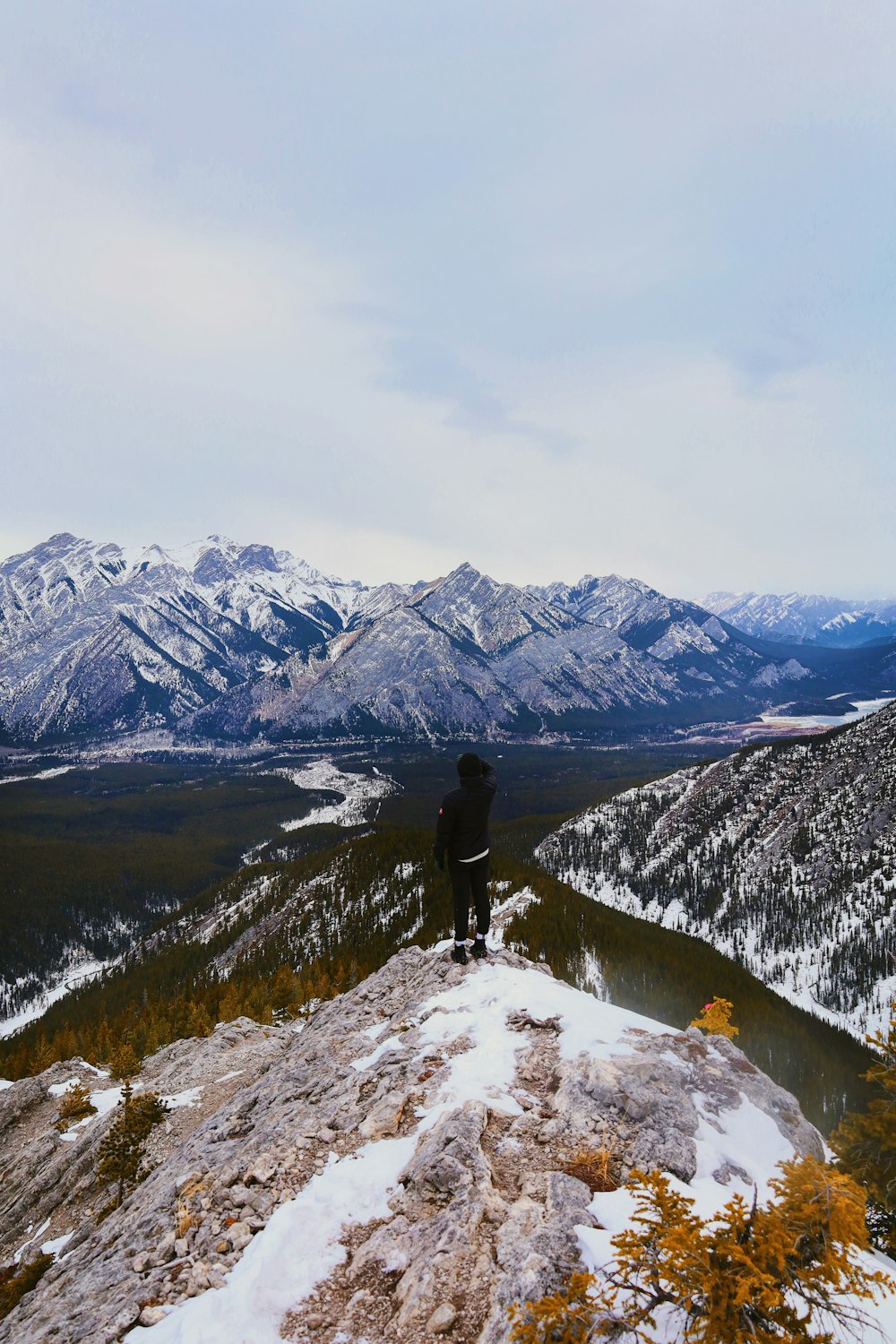 a person standing on top of a snow covered mountain