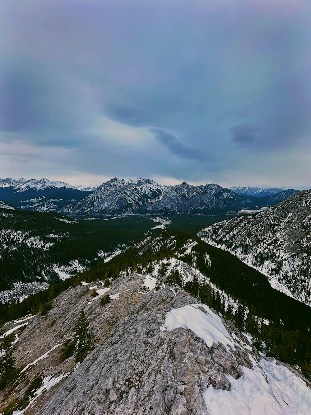 a snowboarder is standing on top of a mountain