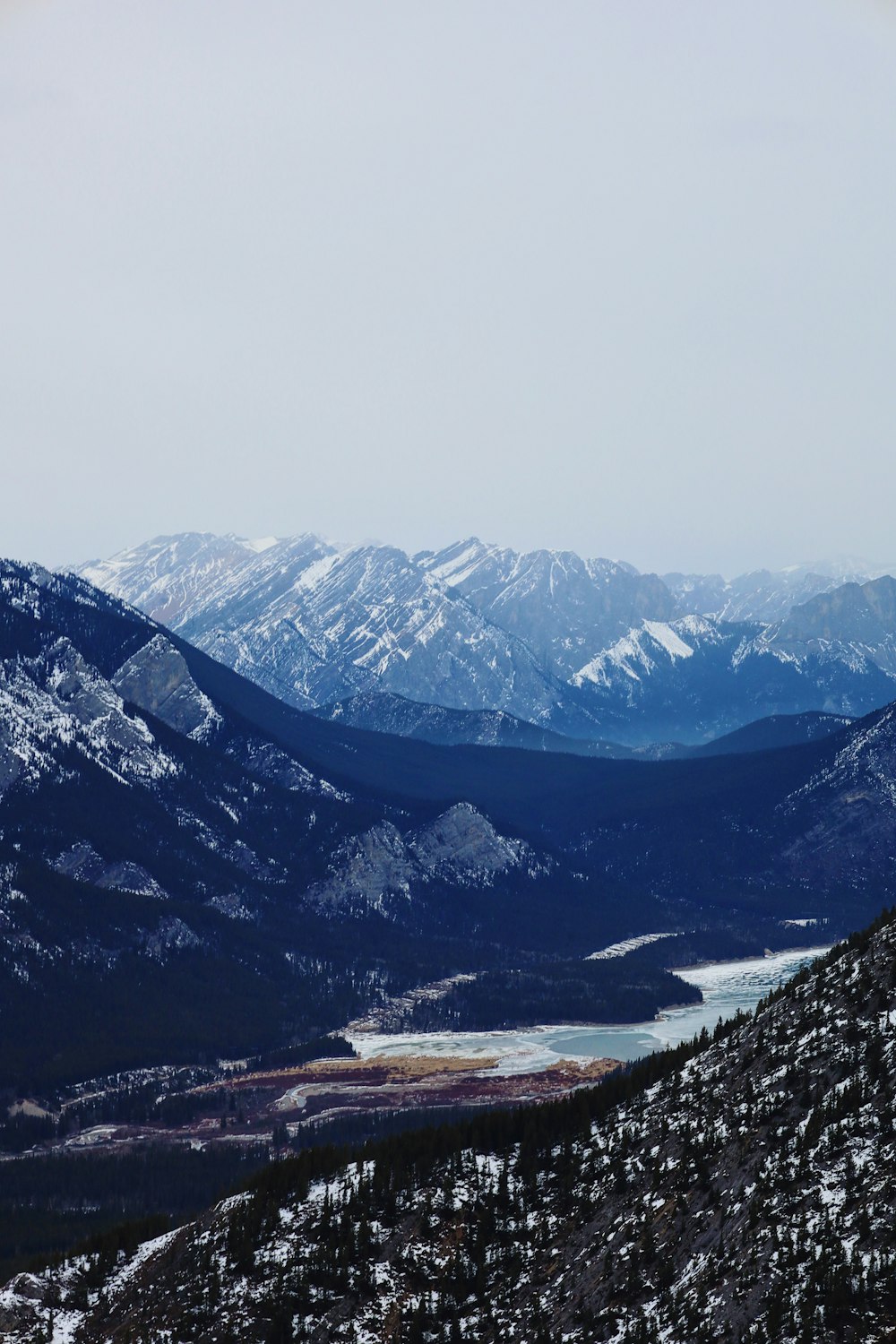 a view of a mountain range with a lake in the middle