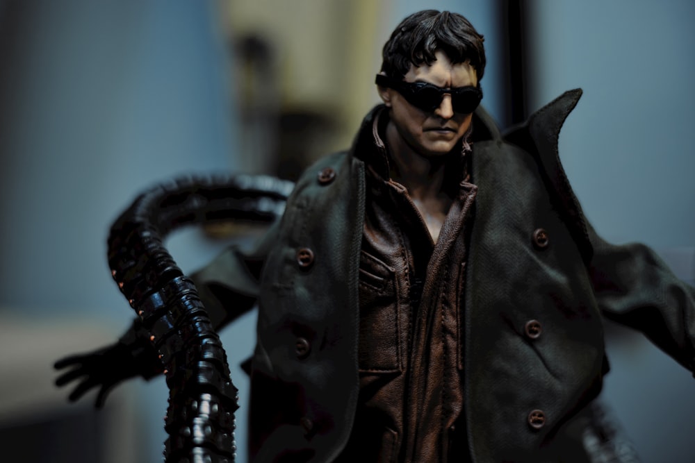 a close up of a action figure wearing a trench coat