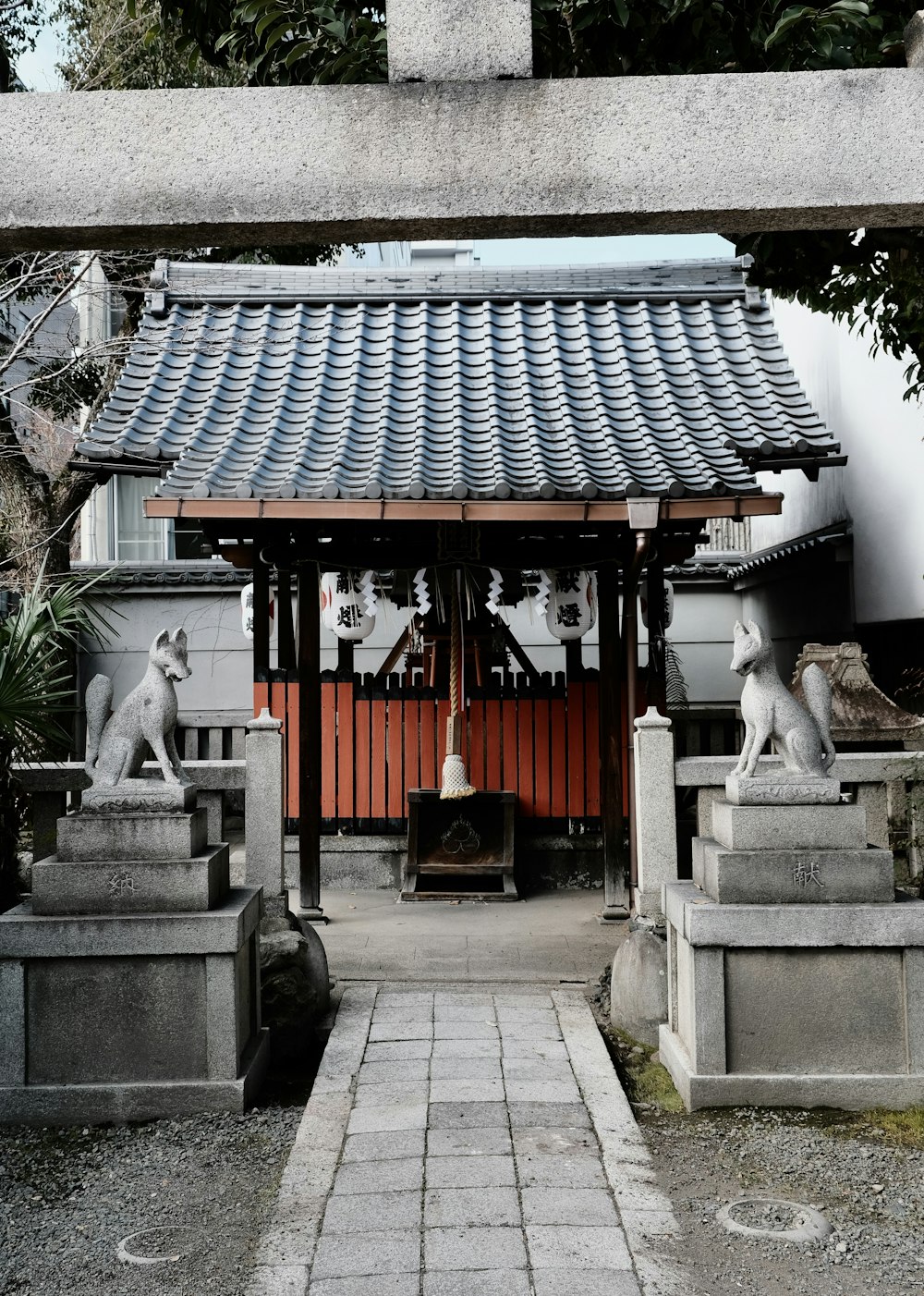a small shrine with statues of dogs on either side of it