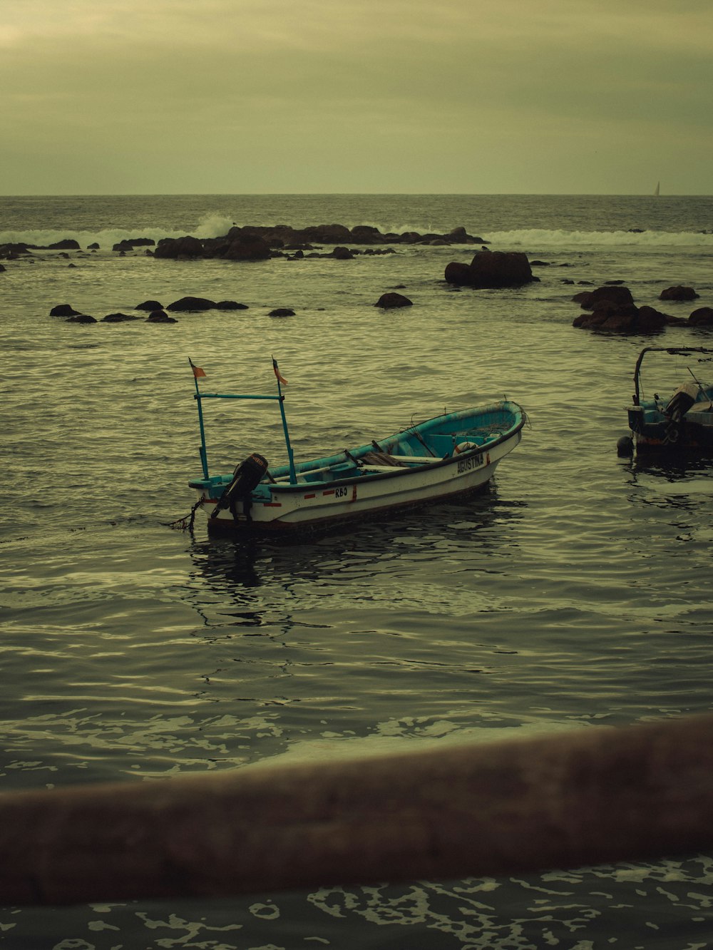 a small boat floating on top of a body of water