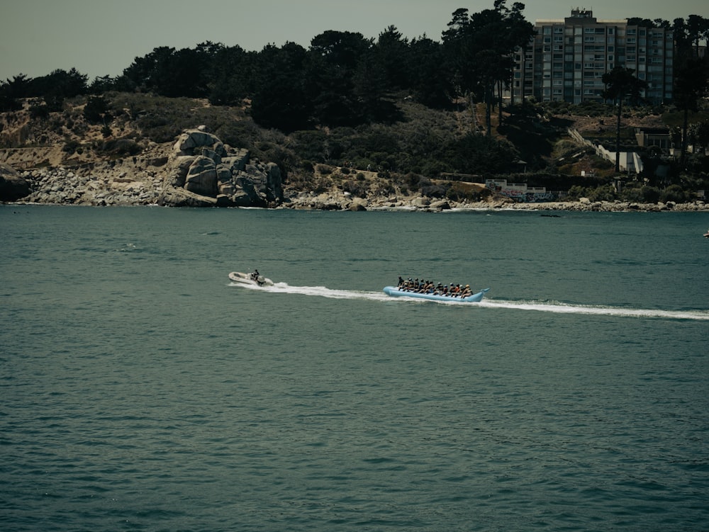 a group of people riding on the back of a boat