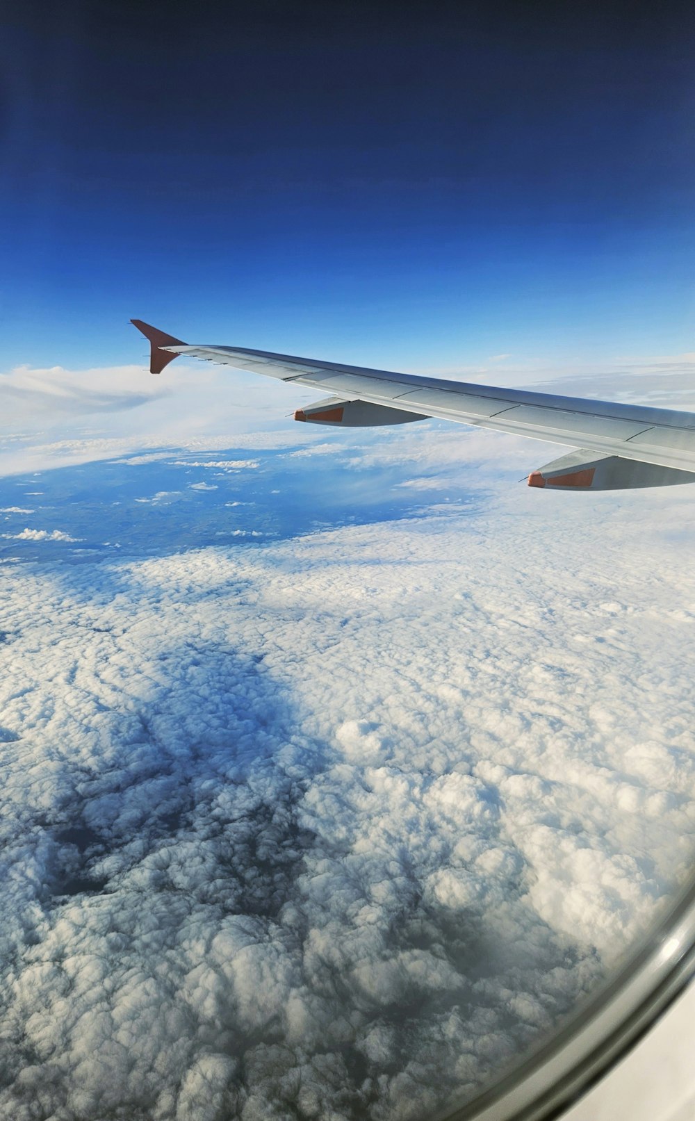 a view of the wing of an airplane in the sky