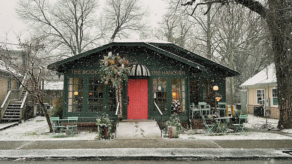 a small green building with a red door