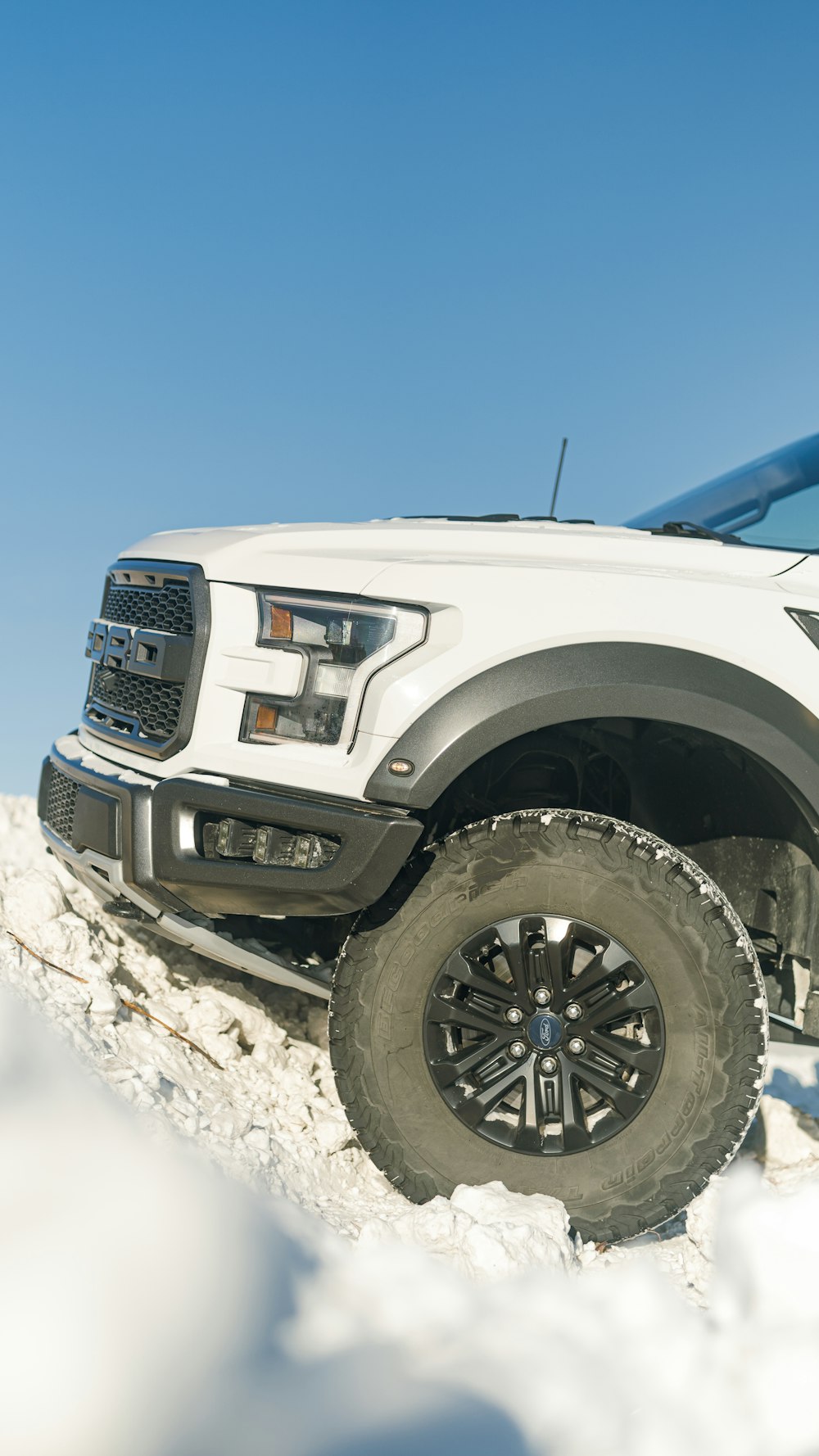 a white truck is parked in the snow