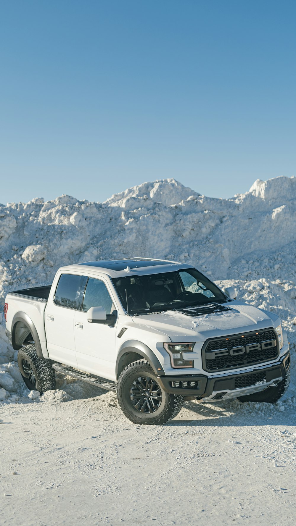 a white truck is parked in the snow