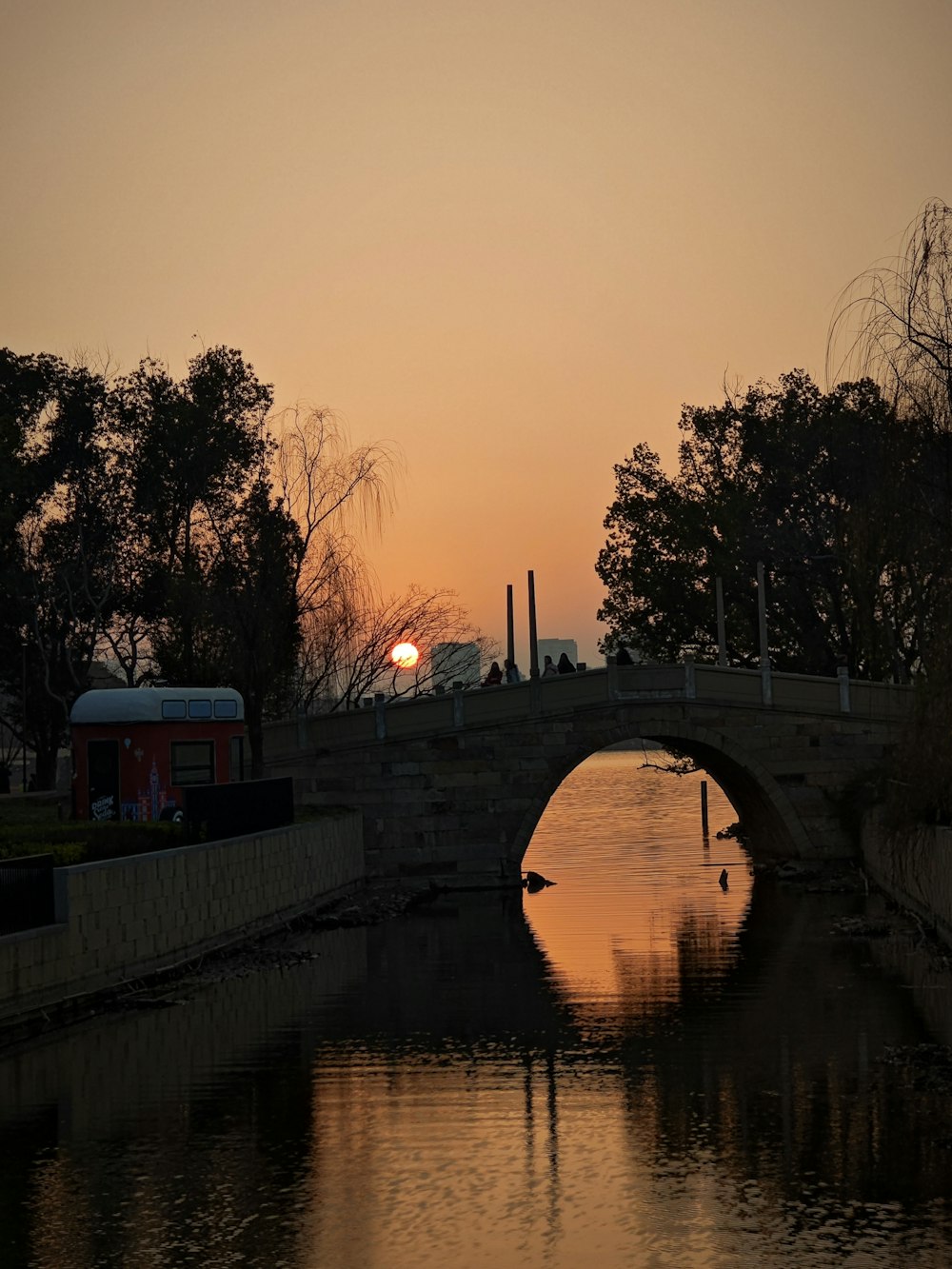 a bridge over a body of water at sunset