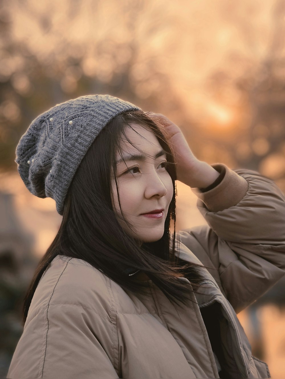 a young woman wearing a hat and jacket