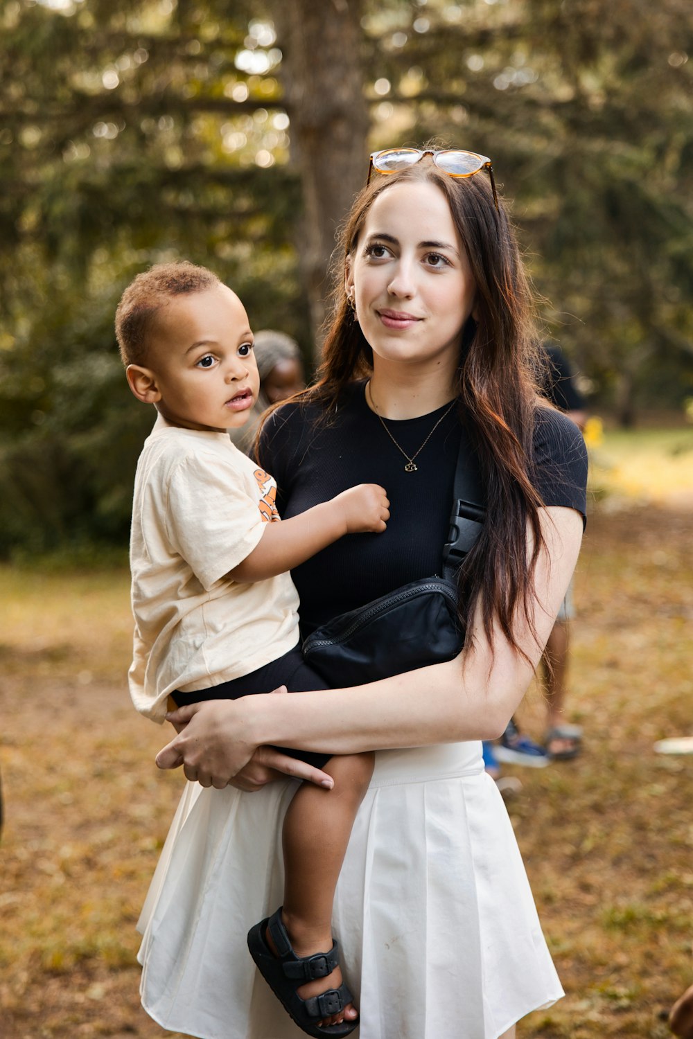 a woman holding a small child in her arms