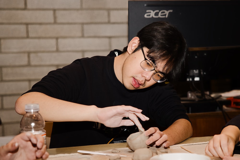 a man is making a vase out of clay