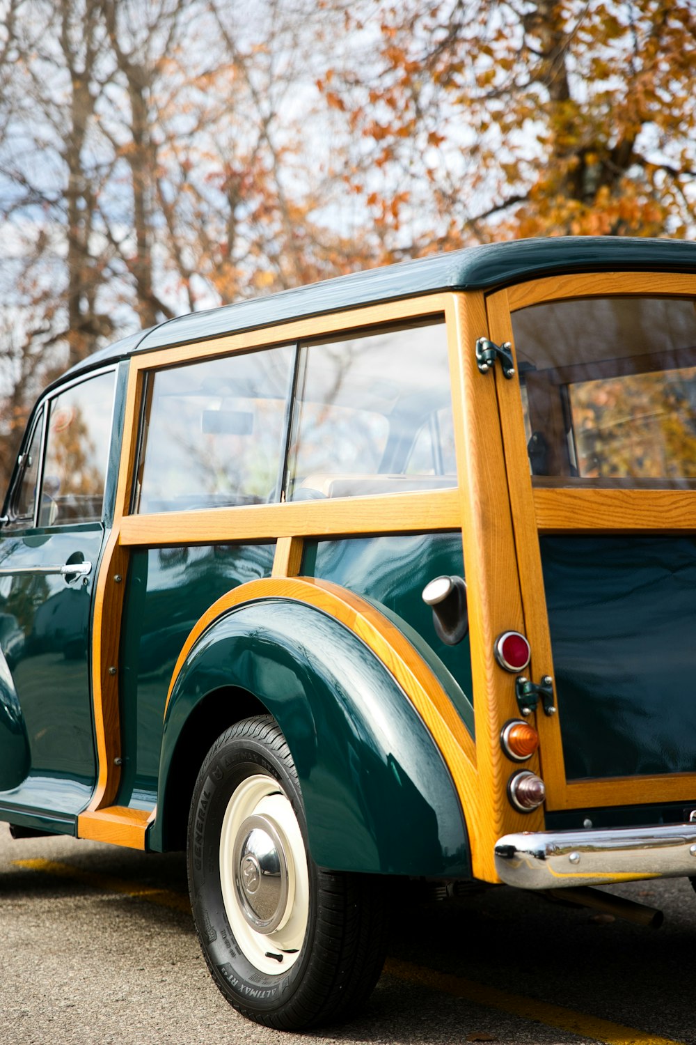 a green and yellow car is parked on the street