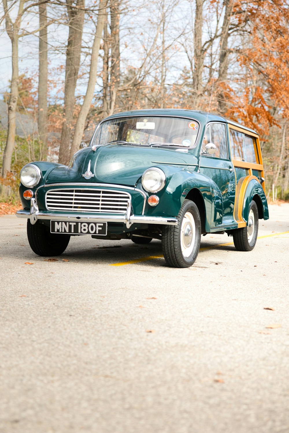 an old car is parked on the side of the road