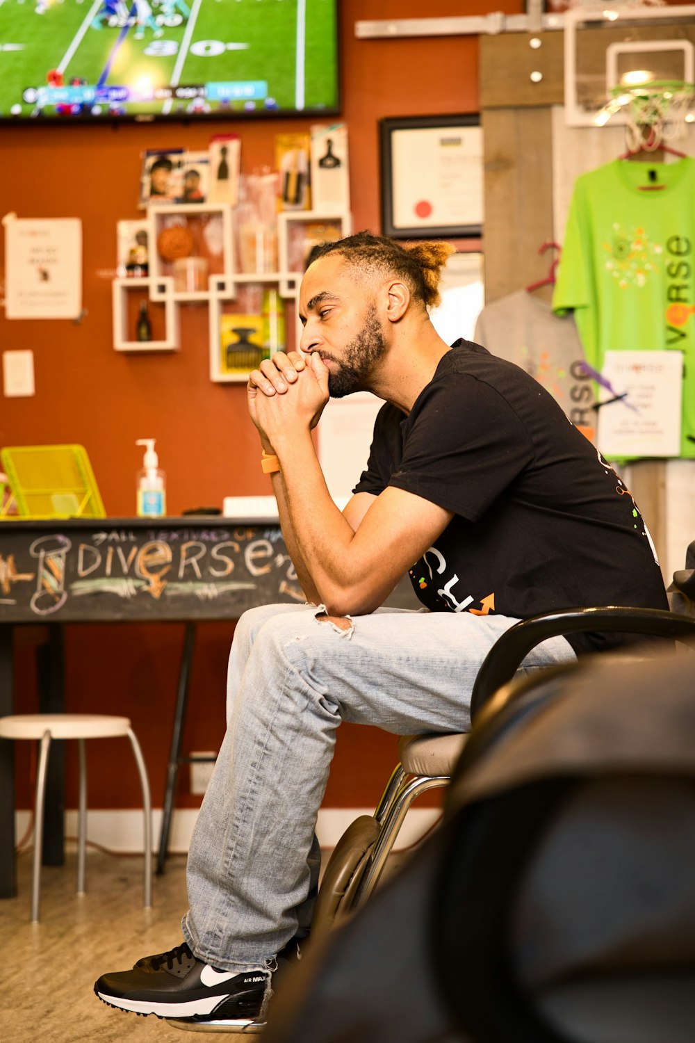 a man sitting on a chair in a barber shop