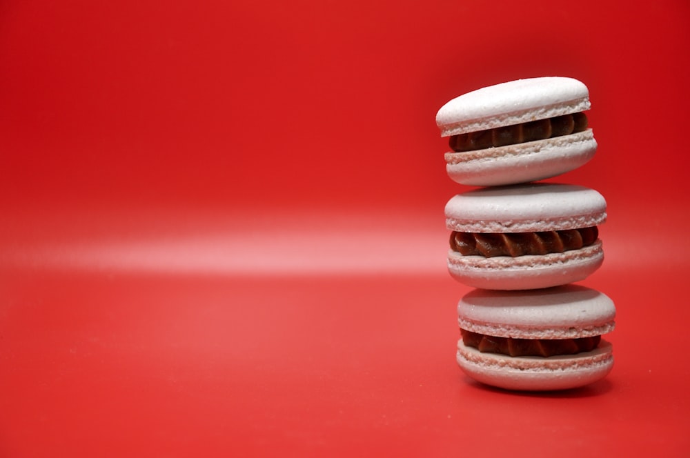 a stack of white and chocolate donuts sitting on top of each other