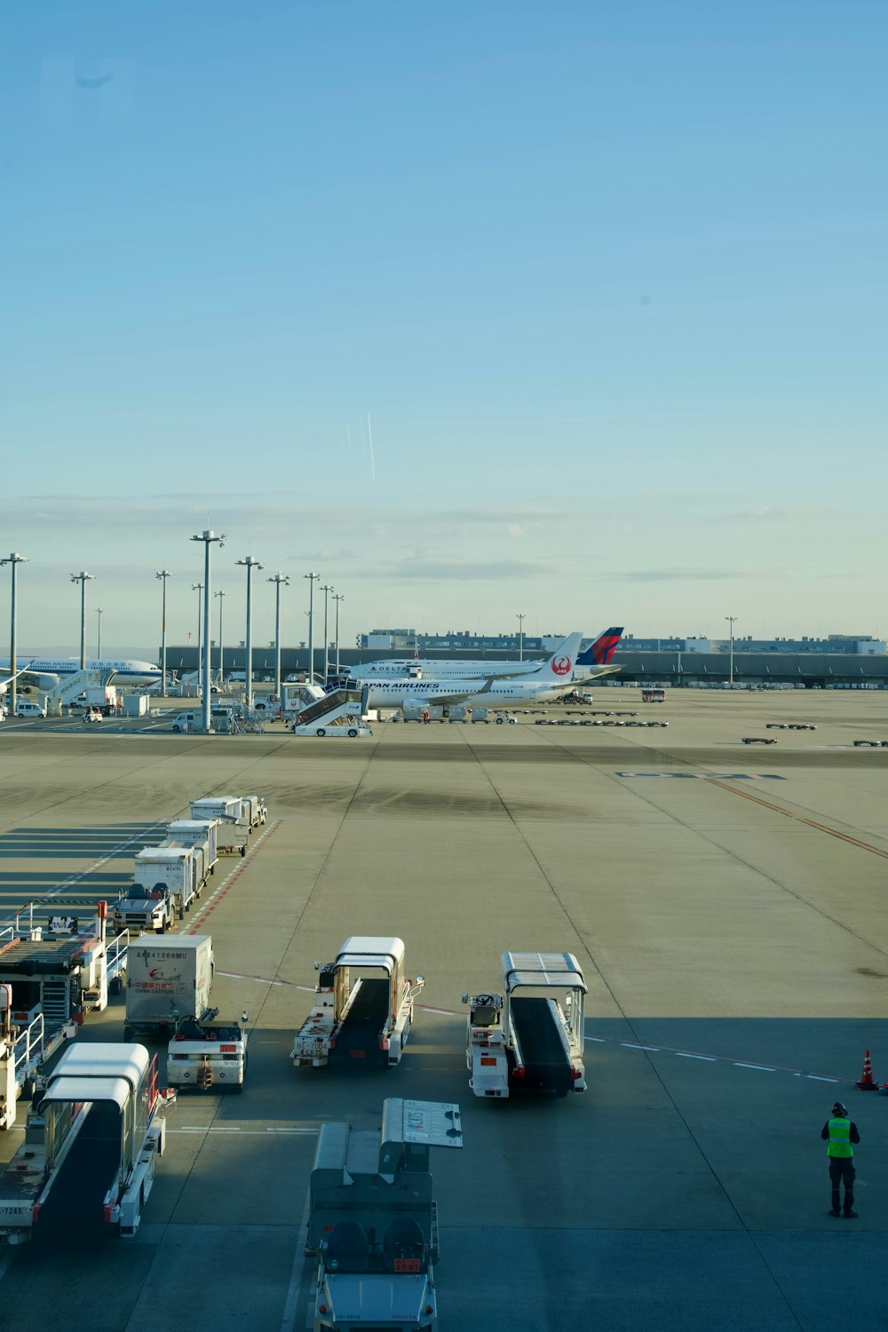 an airport tarmac filled with lots of vehicles