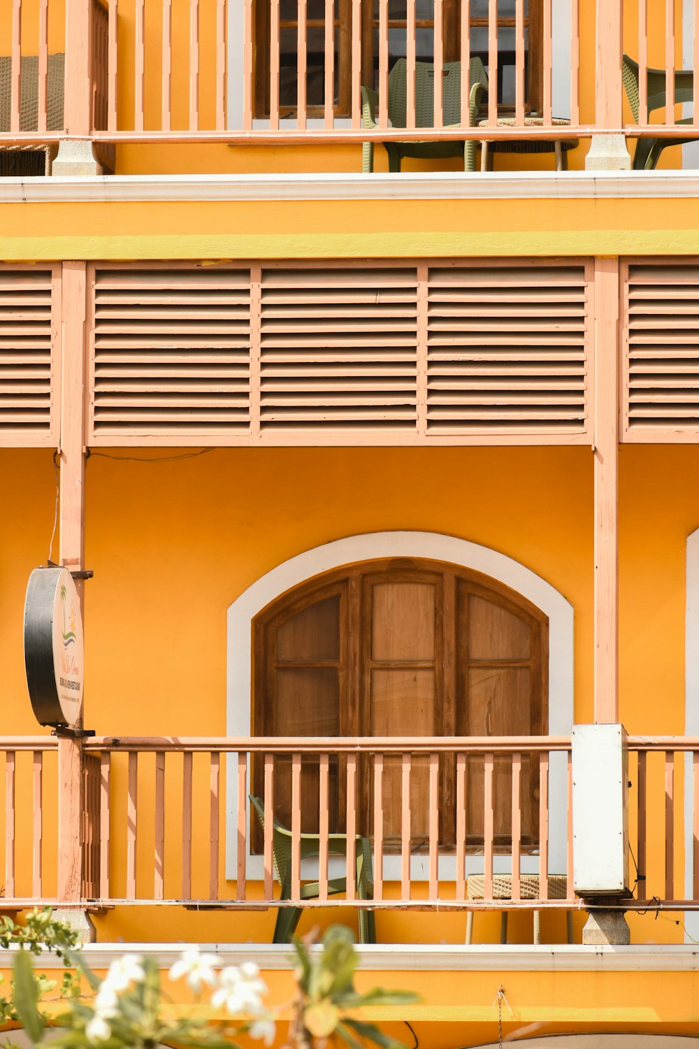 a yellow building with a clock on the front of it