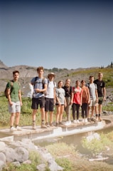 a group of young people standing on a bridge
