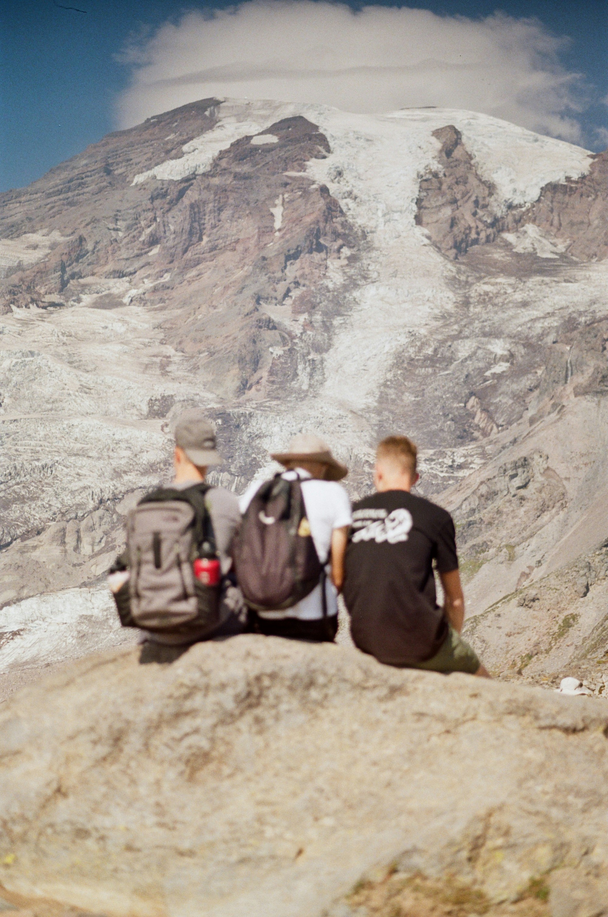 A couple of people sitting on top of a mountain photo – Free Portrait ...