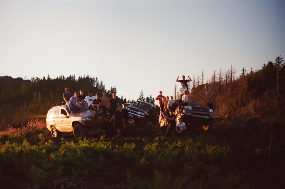 a group of people standing next to a white truck