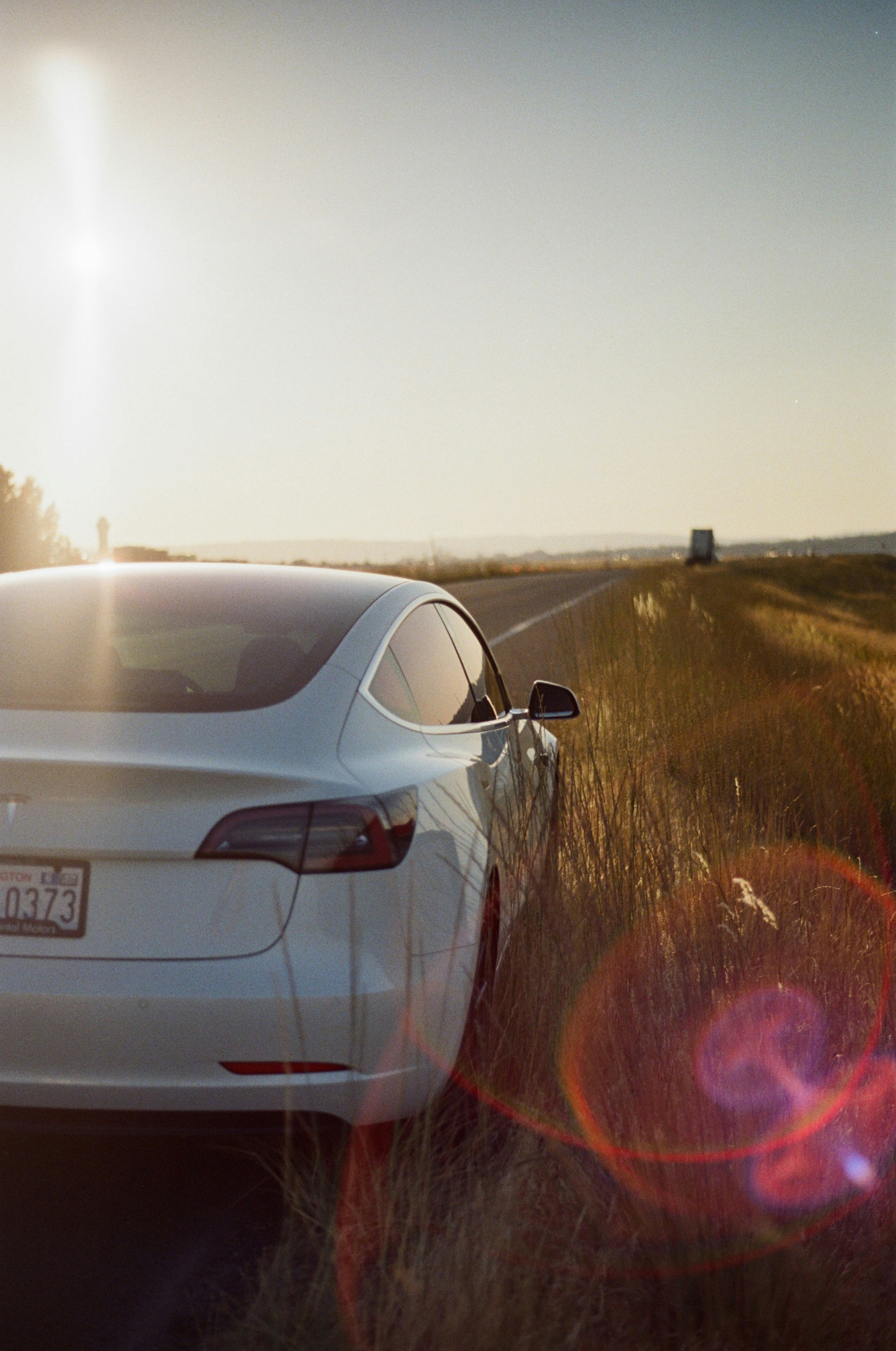 A white car parked on the side of the road photo – Free Nature Image on ...