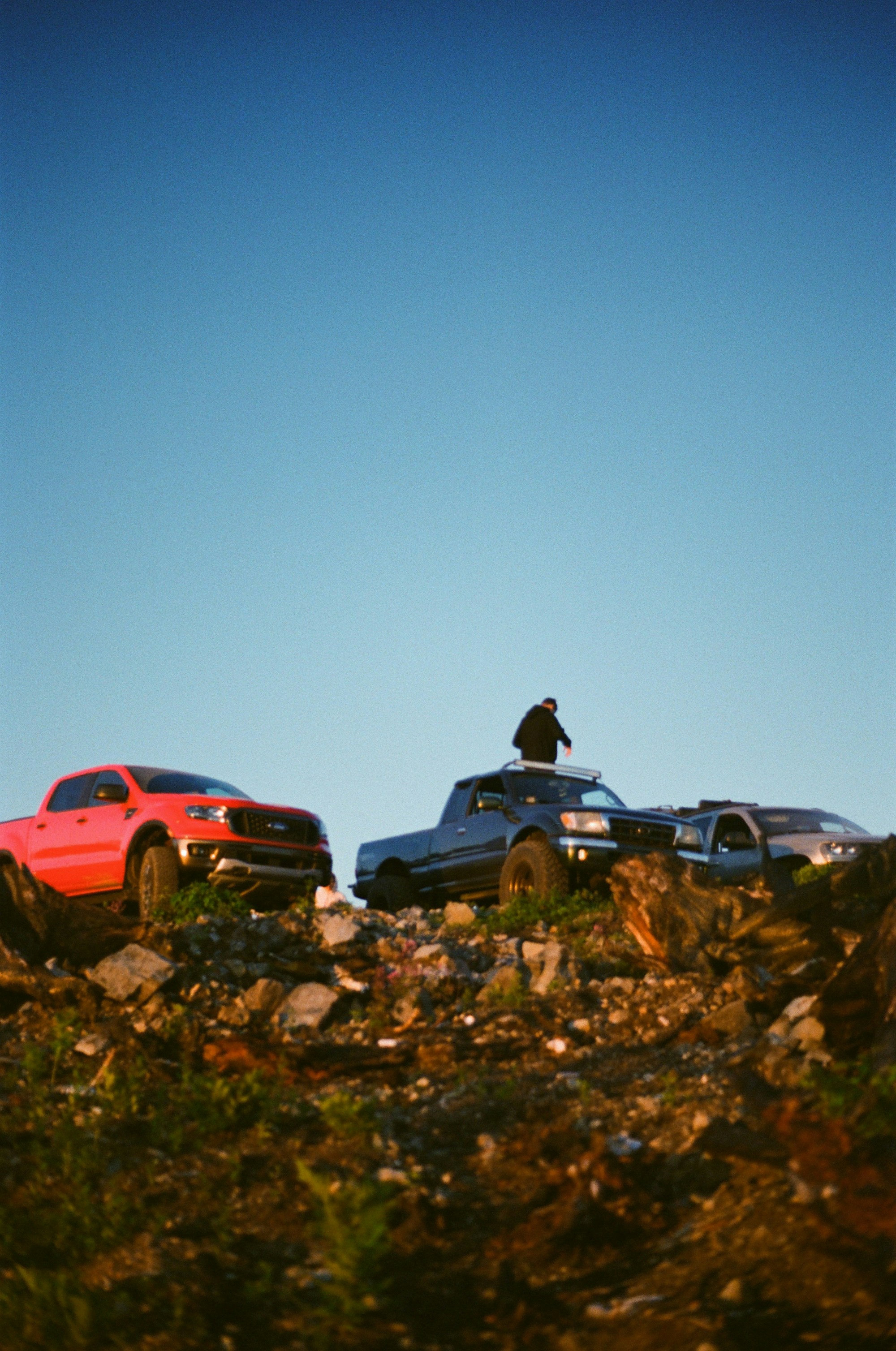 a couple of trucks that are sitting in the grass