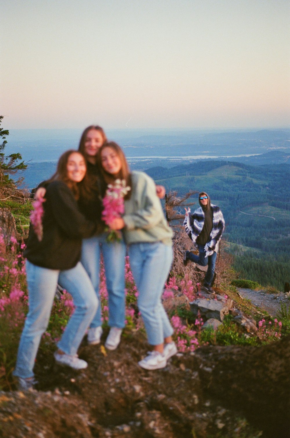 a group of women standing on top of a mountain