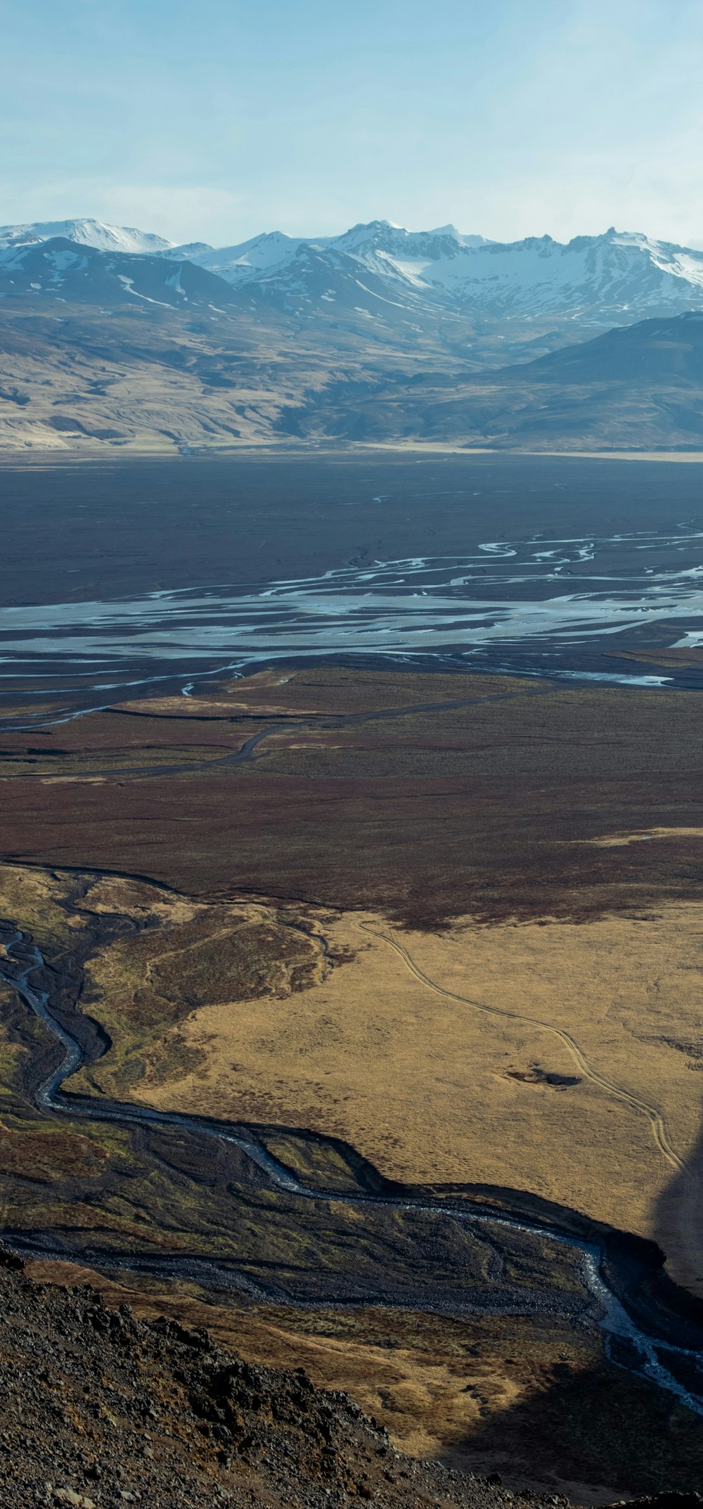 a view of a valley with a river running through it