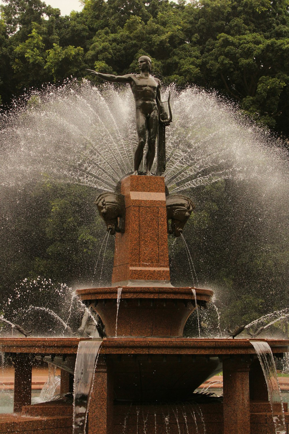 a water fountain with a statue on top of it