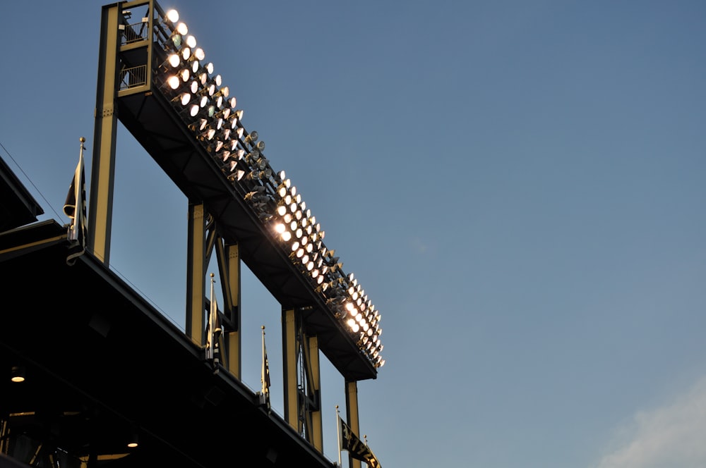 a baseball stadium with lights on and a sky background