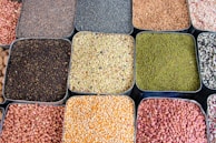 a variety of beans and cereals in trays