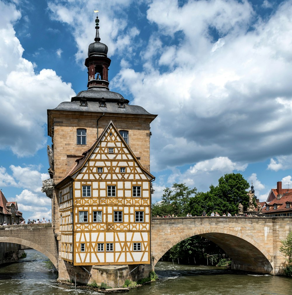 a building with a tower and a bridge in the background