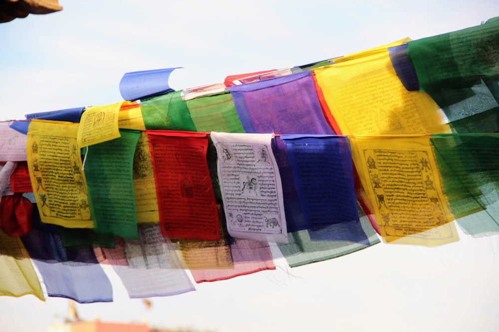 a bunch of colorful flags hanging from a line