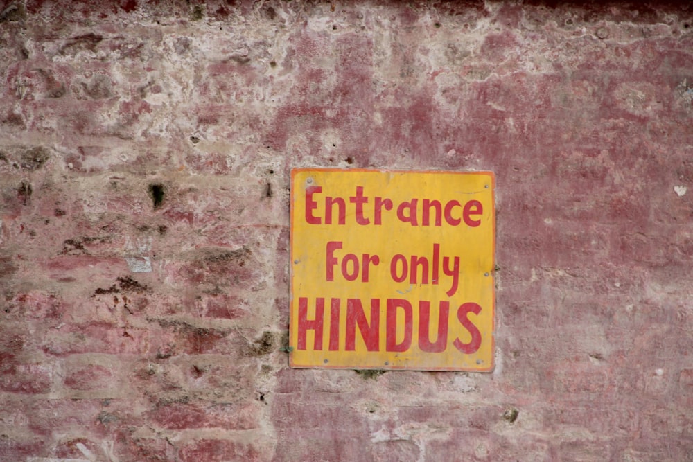 a sign on the side of a building that says entrance for only hindus