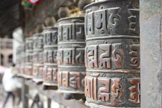 a row of metal bells with asian writing on them