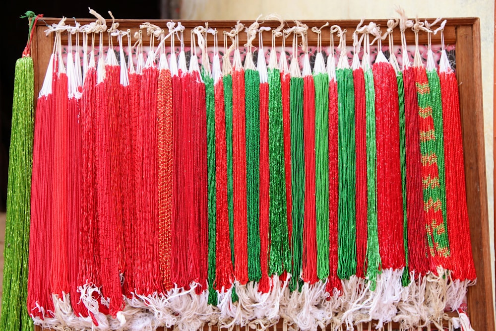 a close up of a bunch of red and green string