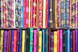 a shelf filled with lots of different colored ties