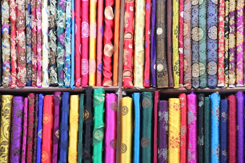 a shelf filled with lots of different colored ties