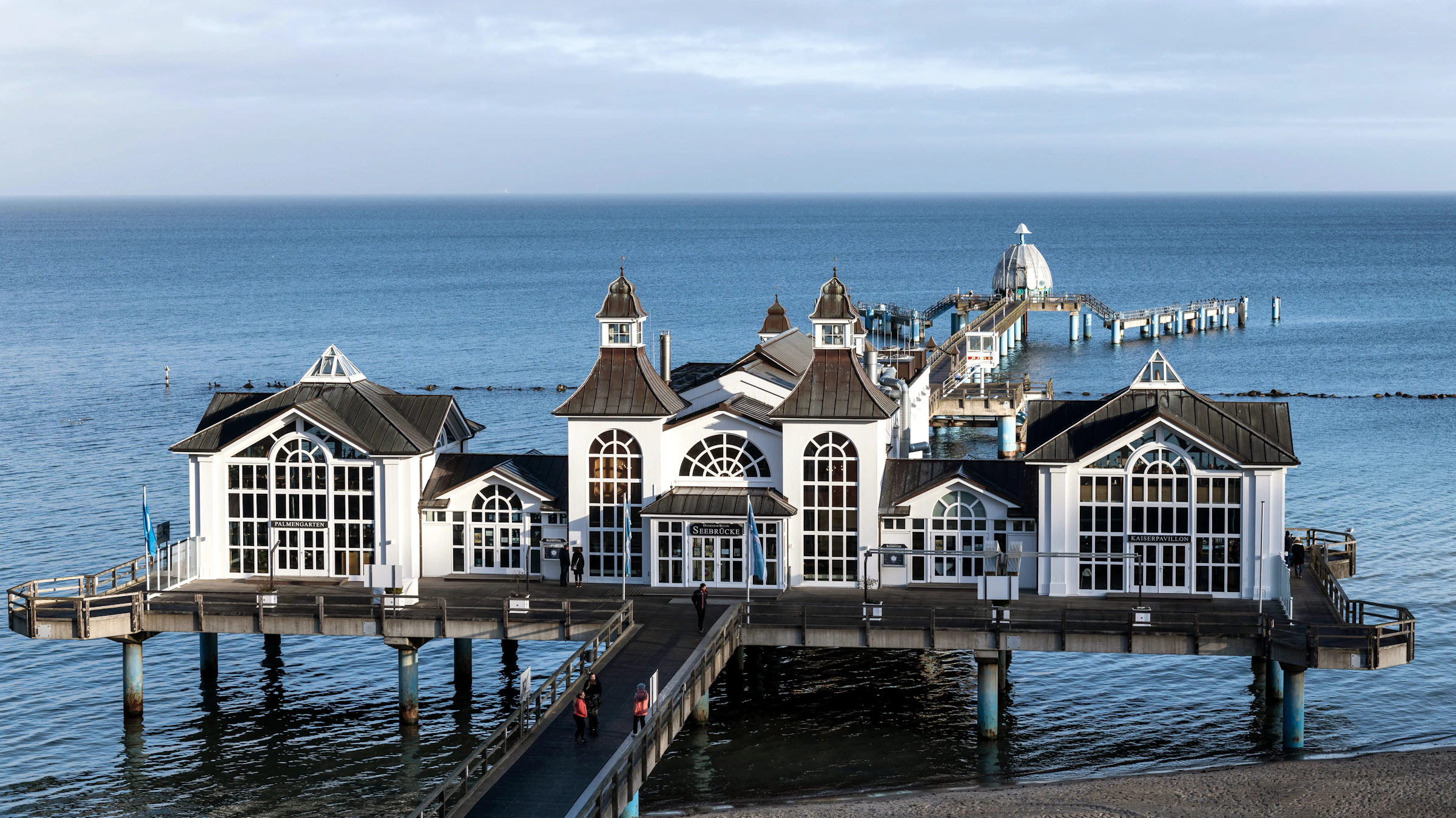 The Sellin Seebrücke pier complex with its white pavilions over a calm Baltic Sea — Rügen, Germany