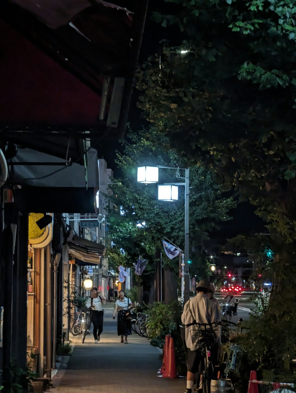 a man riding a bike down a street at night