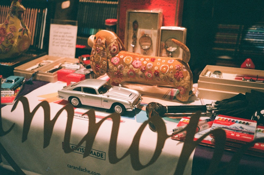 a table topped with lots of toy cars and toys