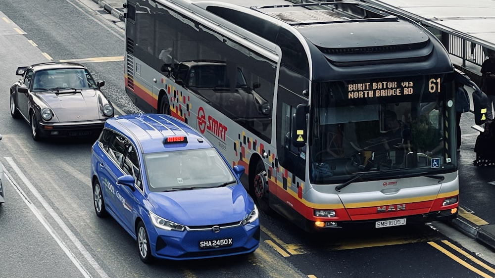 a blue car and a bus on a city street
